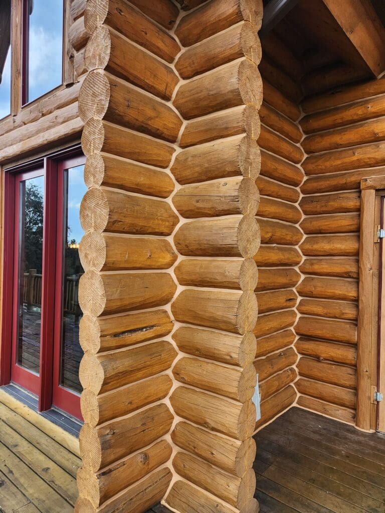 An entrance to a log cabin is show with newly installed cabin chinking to insulate it from the Black Hills weather.